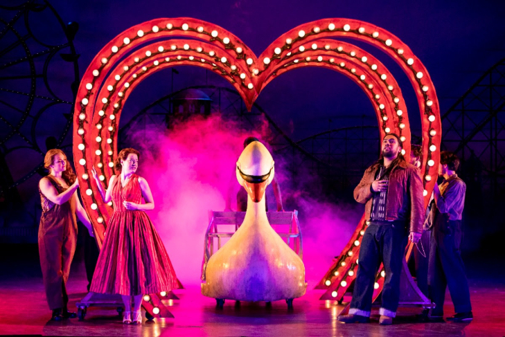 Top things to do in London in February 2026: four performers on stage, either side of a giant neon heart, with a giant swan emerging from the middle of it
