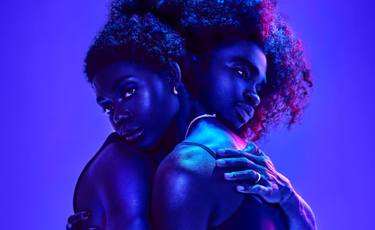 Things to do in London this weekend: two people hugging, bathed in a blue light