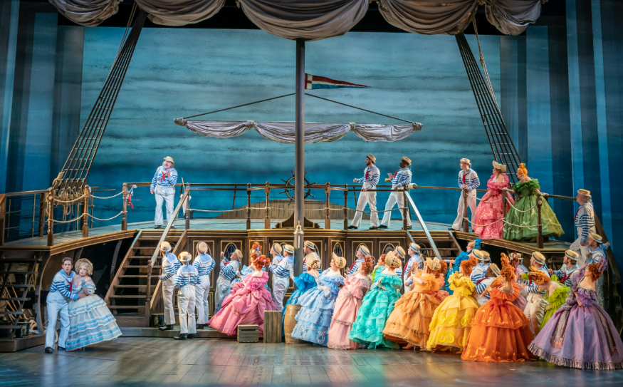 Things to do in London today: a cast of women in colourful dresses in a ship scene in HMS Pinafore