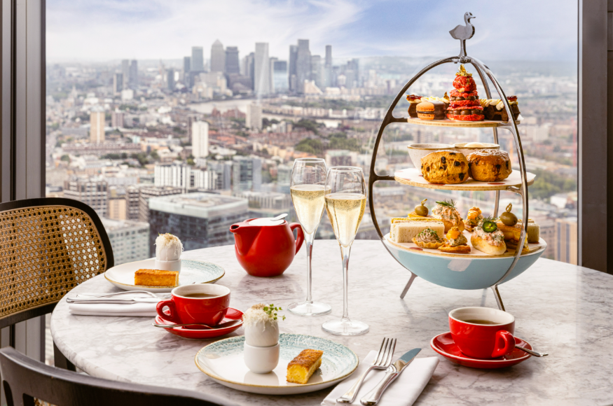 Top events in London today: an afternoon tea stand on a restaurant table with views over London beyond