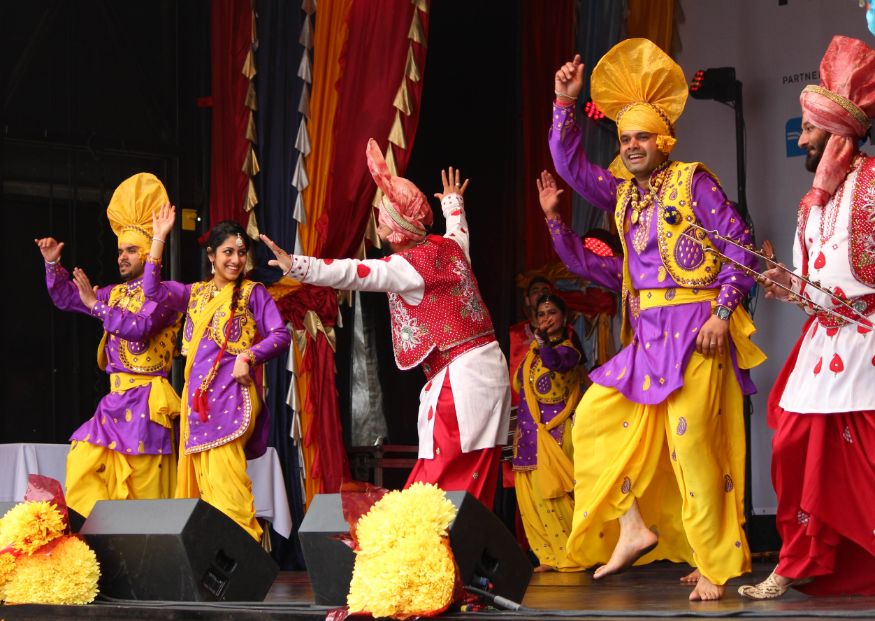Vaisakhi in London 2026: performers in colourful costume dancing on stage