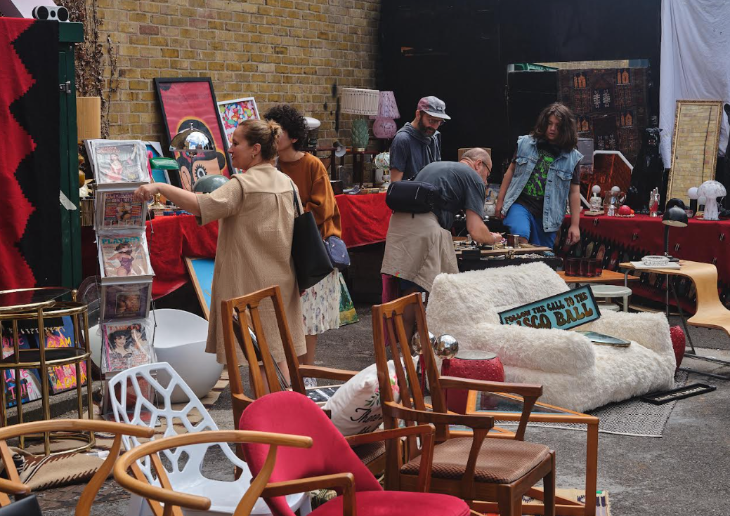 Things to do in London this weekend: people browsing furniture and artworks at a vintage sale