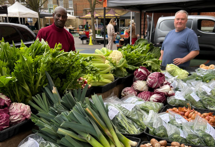 Things to do in London this weekend: two men at a stall selling fresh vegetables