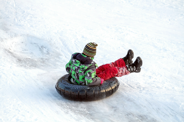 Winter sports in London: somebody sitting in a rubber ring on snow