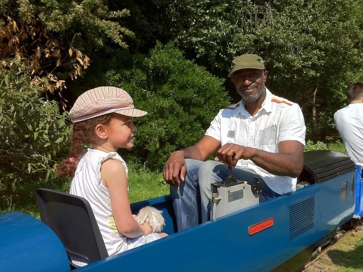 People riding in a small train