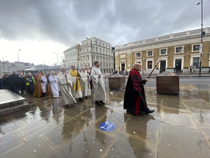 Clergy walking on London Bridge in the rain