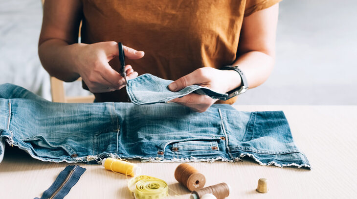 Someone repairing a pair of jeans