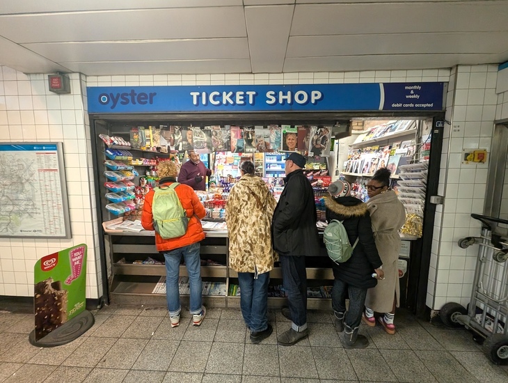 People gather in front of the stall