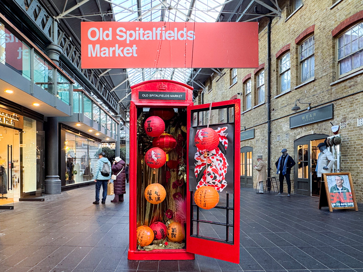 A telephone box filled with Chinese lanterns