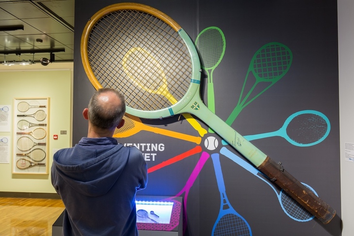A man studying a huge racket