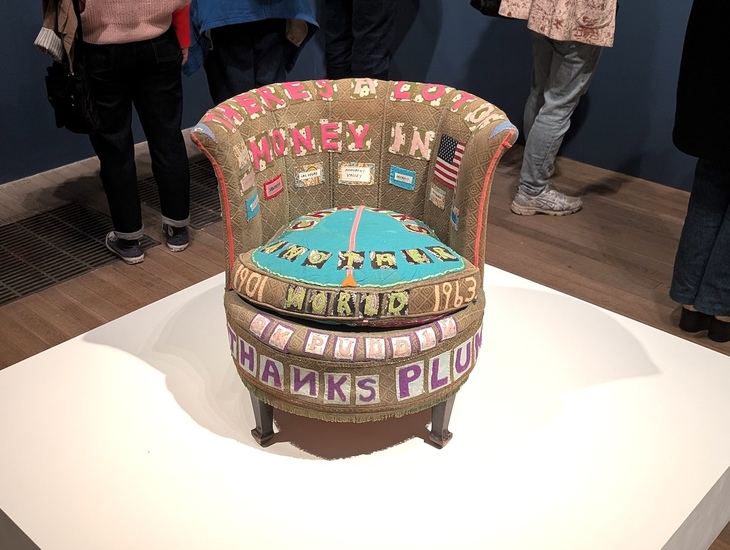 A chair embroidered with various words and patterns