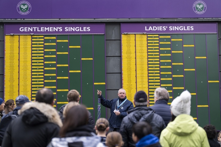 A guide pointing at scores