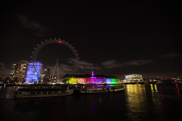 What's on in London March 2026:  the London Eye in complete darkness at night, while County Hall is lit in rainbow colours behind