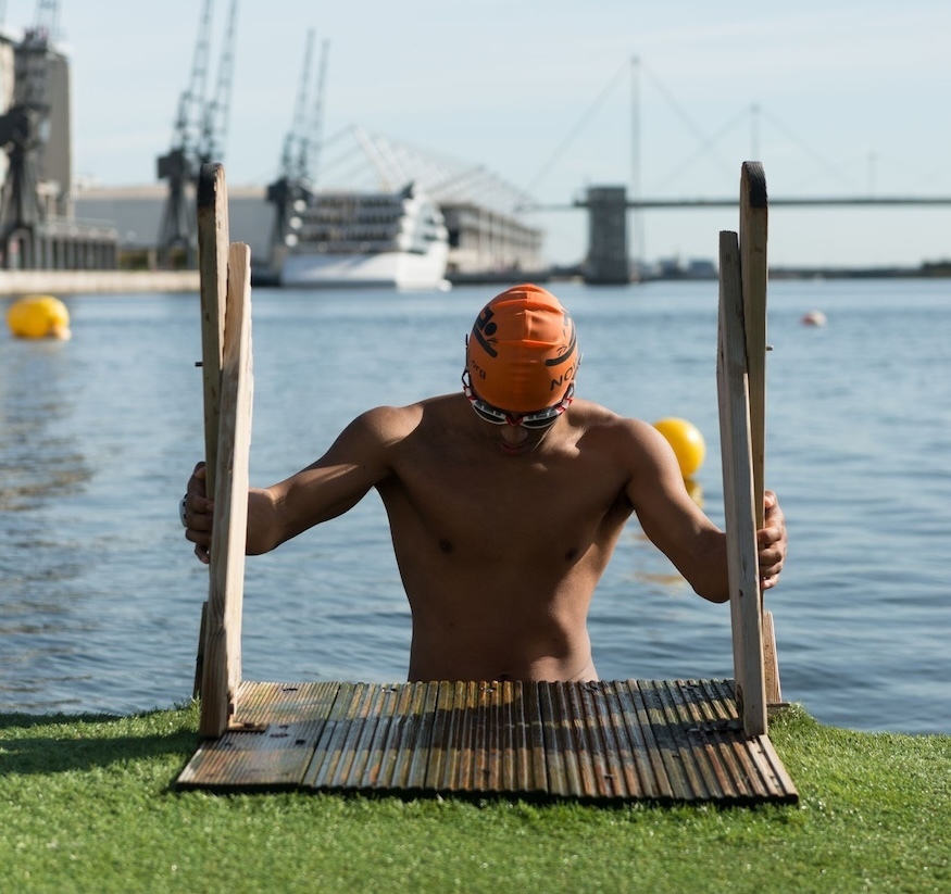A swimmer emerges from the Royal Docks