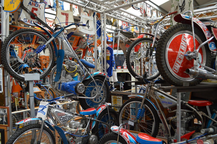A collection of Speedway bikes on display in a museum