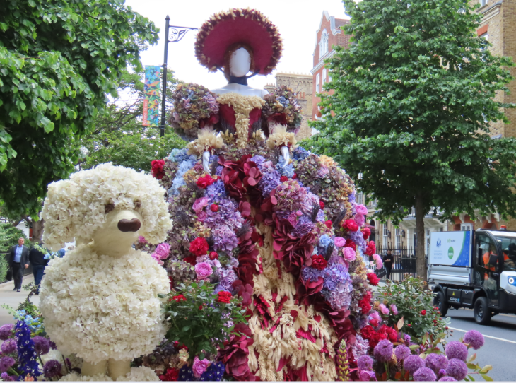 London's best flower displays: a woman in a large pink dress alongside a white poodle, both made from flowers