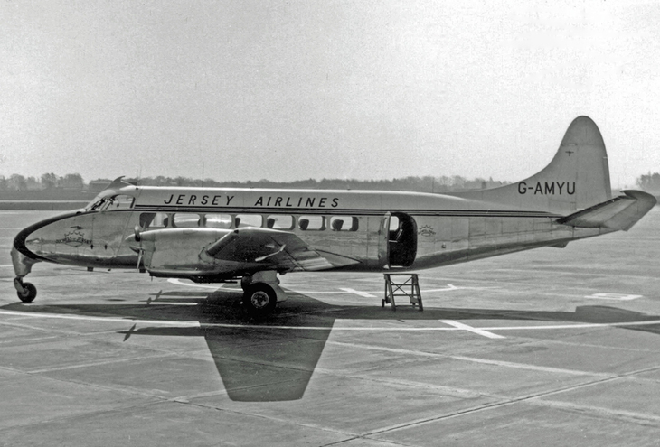 An old fashioned aeroplane on a runway in black and white