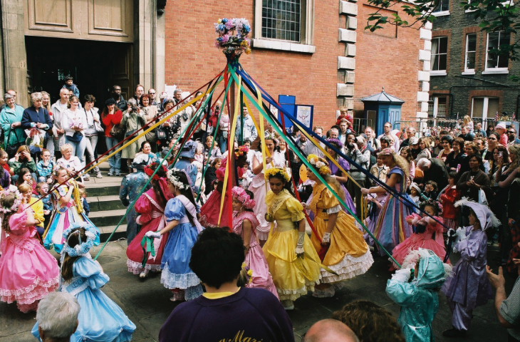 Covent Garden Puppet Festival:  children dancing around a maypole, watched by a crowd