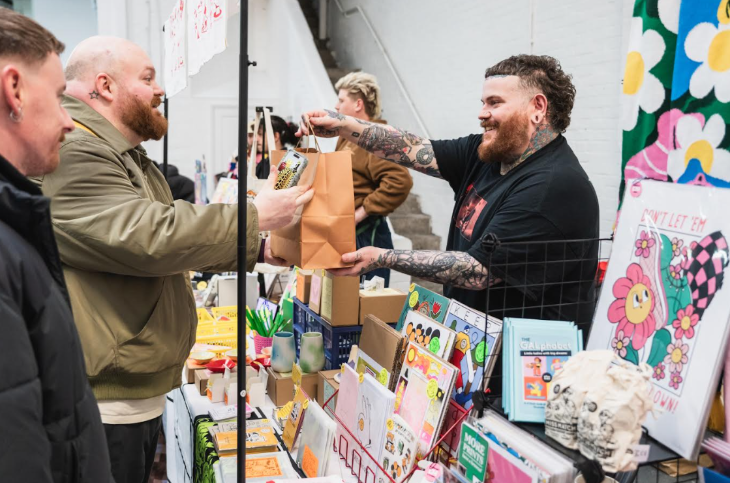 What's on in London this weekend: a vendor handing a bag over to a customer at a craft market