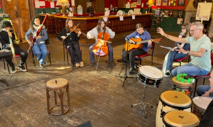 Some people in a pub playing on drums