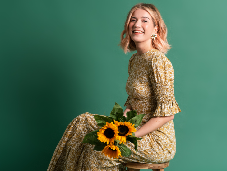 Top events in London today: Olga Koch sitting down, holding a bunch of sunflowers in her lap