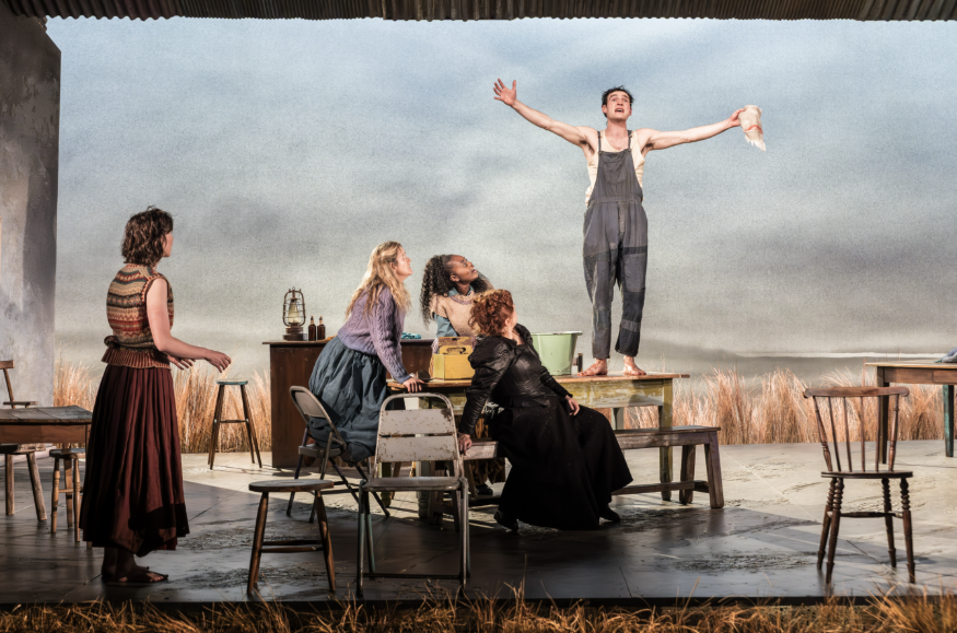 Top things to do in London today: a man standing on a table with four people looking up at him, on stage during a performance of The Playboy of the Western World