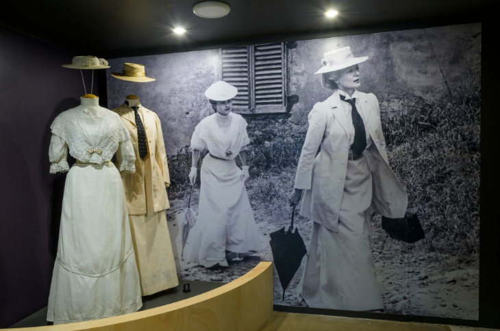 What's on in London this weekend: two costumes on display on mannequins, in front of a large-scale still from the film in which they feature