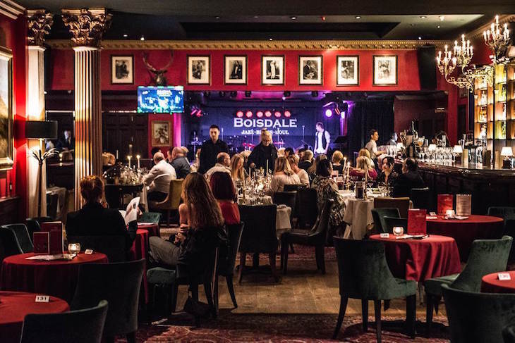 velvet lounge London full of seated people, with others on stage