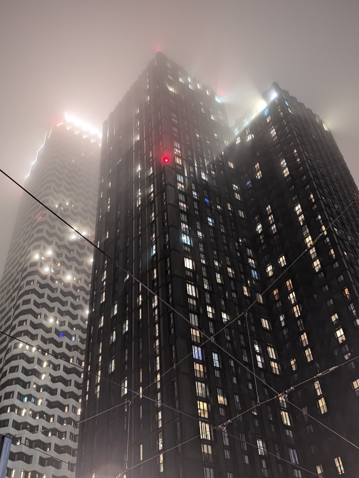 A formidable looking high rise swathed in mist
