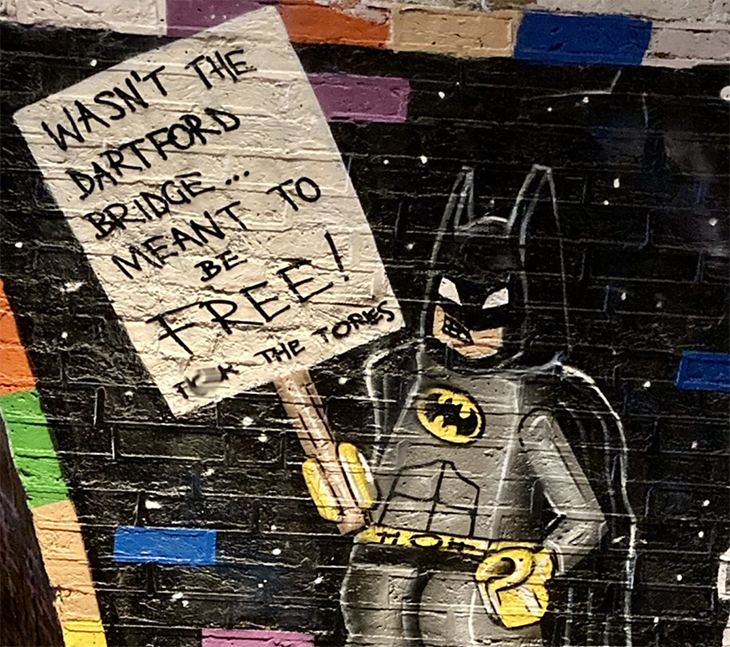Lego Batman holds a placard demanding a toll-free Dartford Crossing