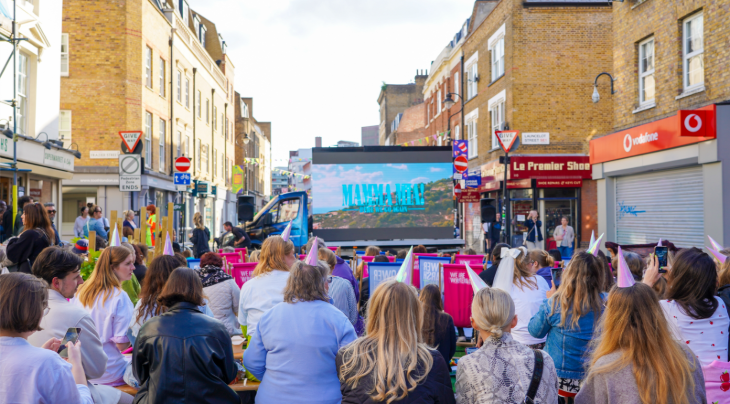 Outdoor cinema London 2026: Lower Marsh closed to traffic with people sitting in deckchairs watching a large screen