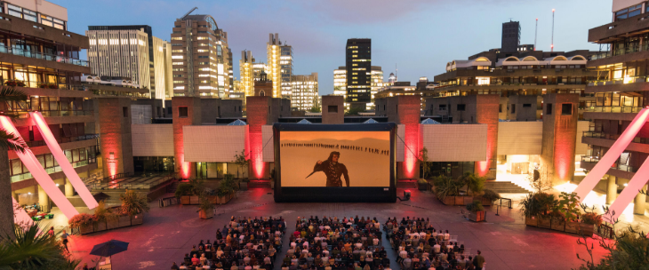 Outdoor cinema London 2026: A large screen and rows of chairs in the courtyard at BArbican