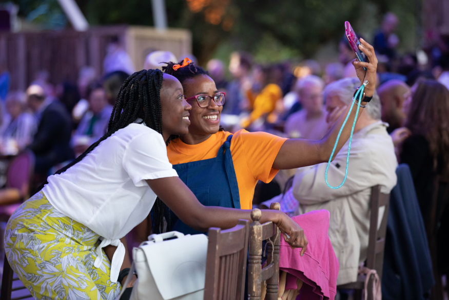 Outdoor activities London in summer: two women taking a selfie in the Opera Holland Park auditorium