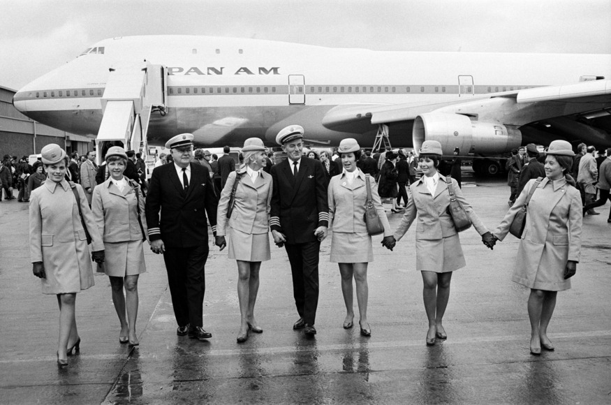 Crew posing in front of a Jumbo Jet