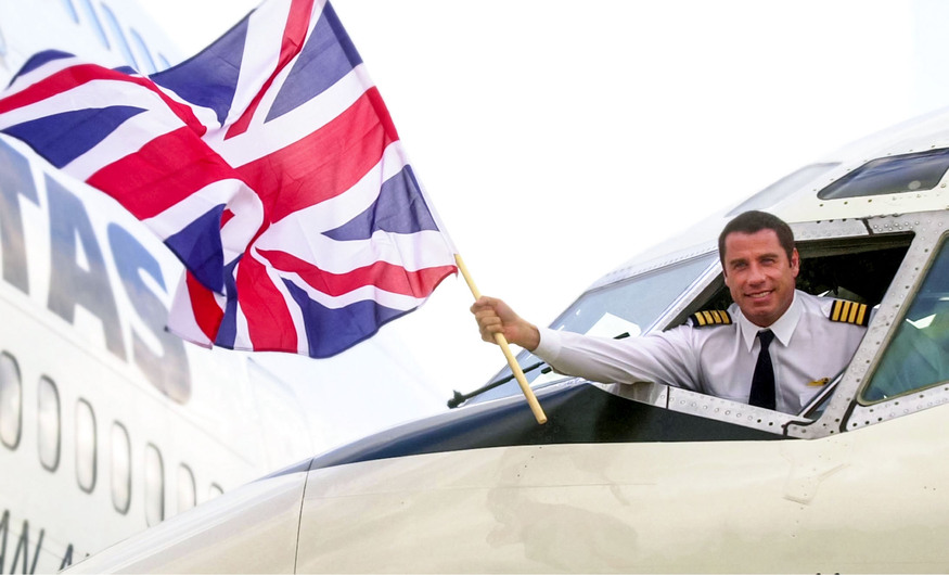 John Travolta holding a Union Flag out of a cockpit
