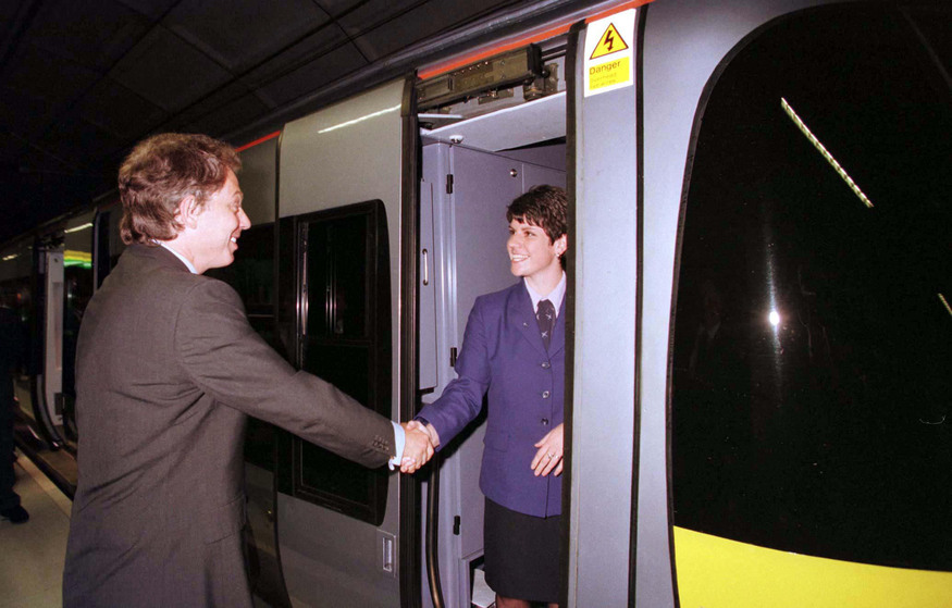 Tony Blair shaking hands with someone on a train