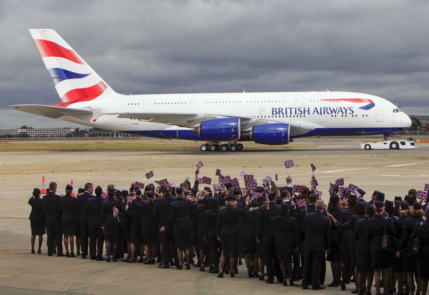 Staff cheering a double decker jet
