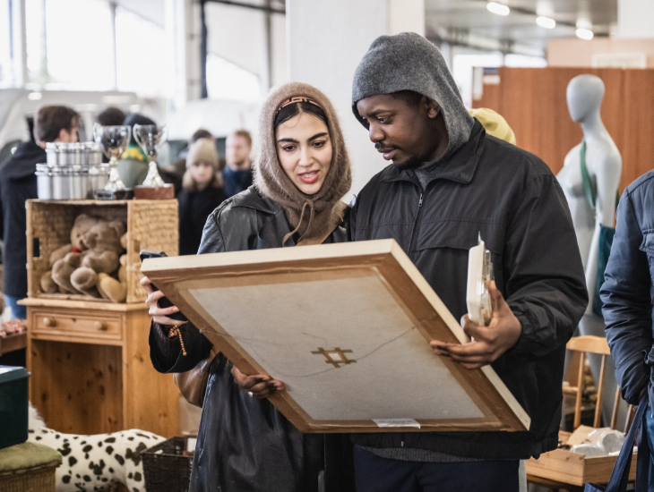 Top events in London this weekend: a woman and woman looking at a painting at a flea market