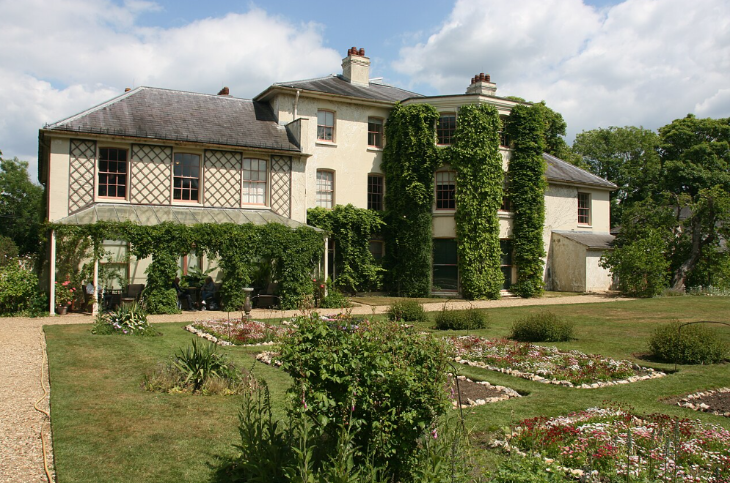 Best things to do in outer London: the exterior of Down House, partially covered with ivy, seen from across the gardens
