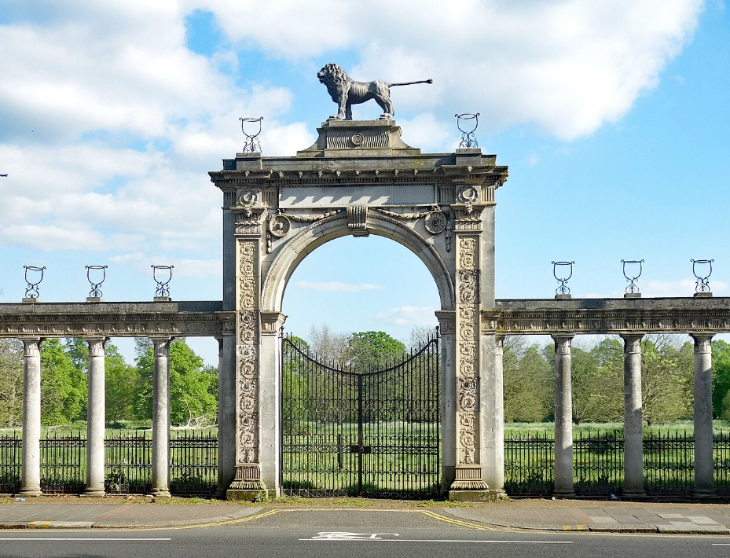 Best things to do in outer London: a stone arch topped with a stone lion over a metal gate