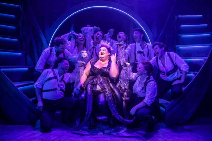 What's on in London in April 2026: The cast surrounding Ursula on stage