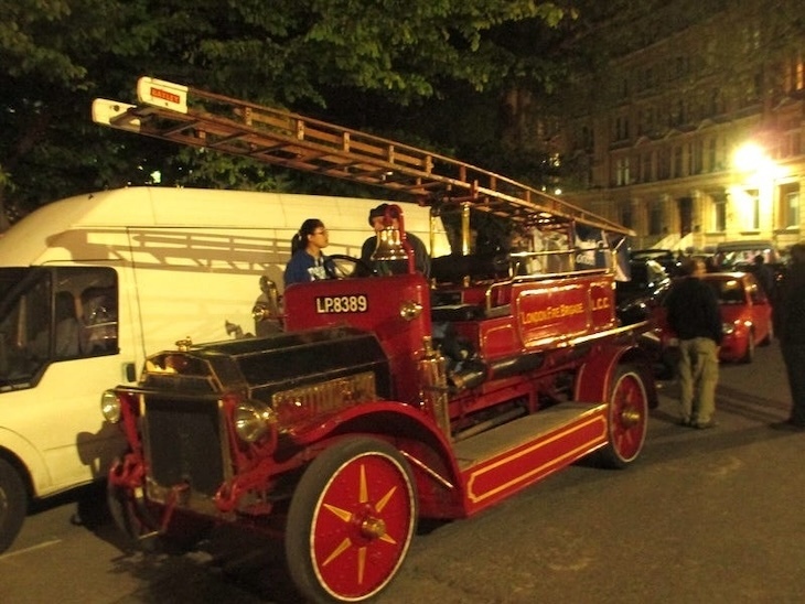 A vintage fire engine at night