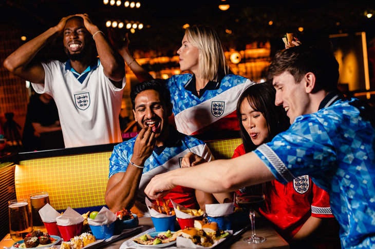 People in retro England shirts