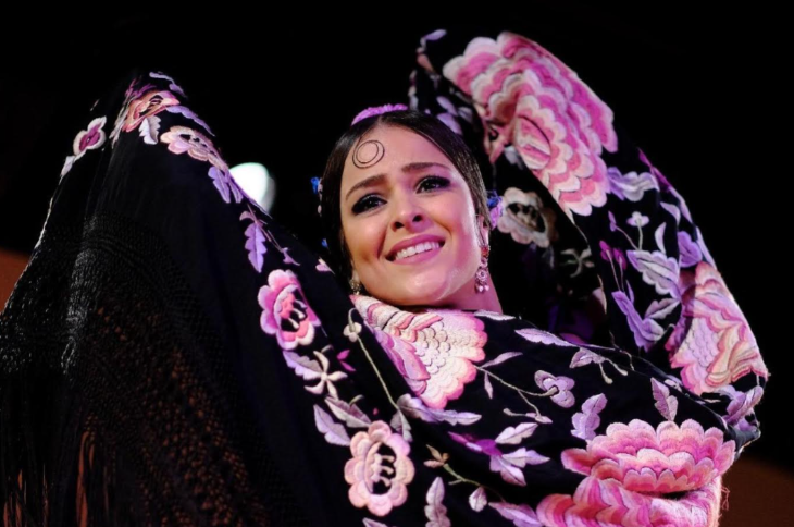 Top things to do in London in May 2026: a flamenco dancer mid-performance, in a black and pink floral costume