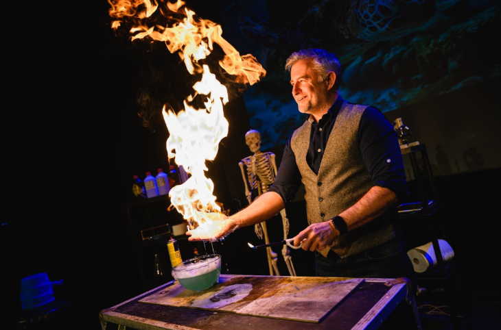 Things to do in London in half term May 2026: a man conducting an experiment with fire, with a skeleton in the background