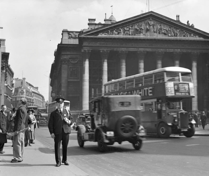 Things to do in London this bank holiday weekend: a black and white photograph of a postman in front of the Royal Exchange