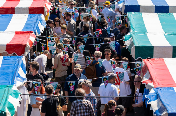 What's on in London this weekend: people walking among market stalls, beneath bunting