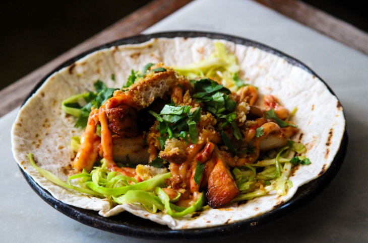 Top events in London today: a dish consisting of an open wrap filled with salad and chicken