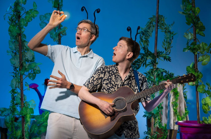 Things to do in London in half term May 2026: two people on stage wearing bug antenna on their heads, one holding a guitar