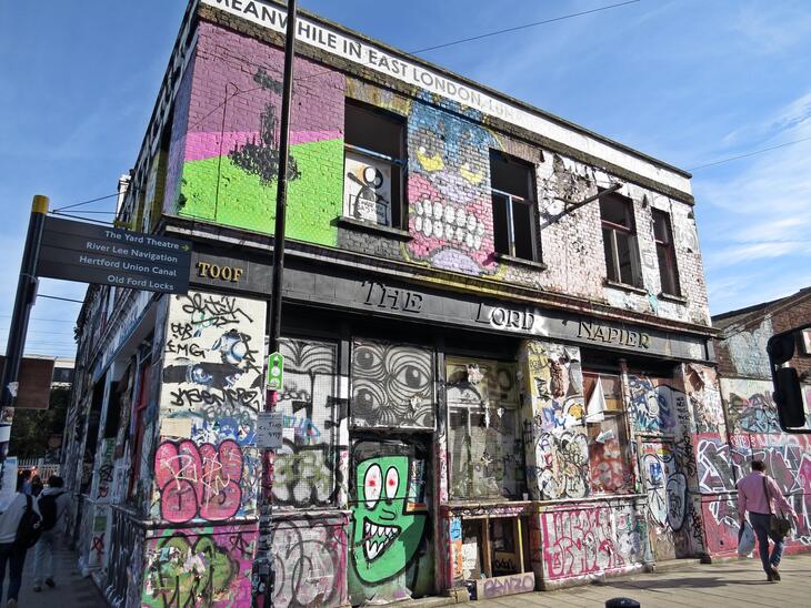 The pub boarded up, slathered in graffiti